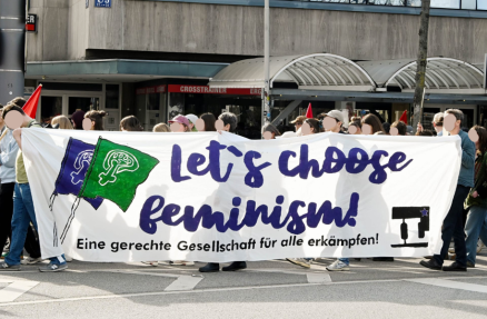 Lets choose feminism! Transparent mit der Aufschrift Lets choose feminsm wird von Aktivist:innen der IL Rhein-Neckar getragen